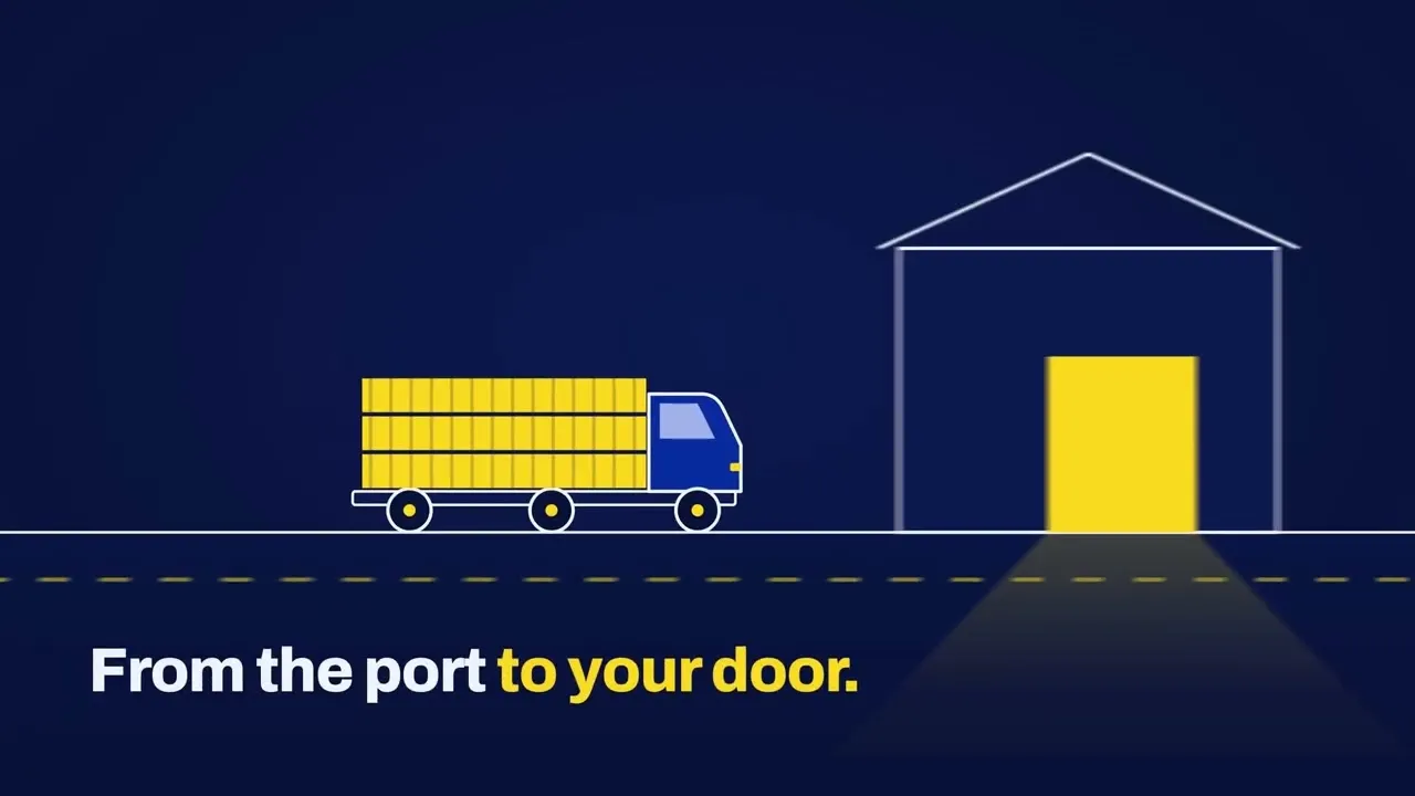 A truck loaded with cargo pulling up to a warehouse, from the Trinity Freight film